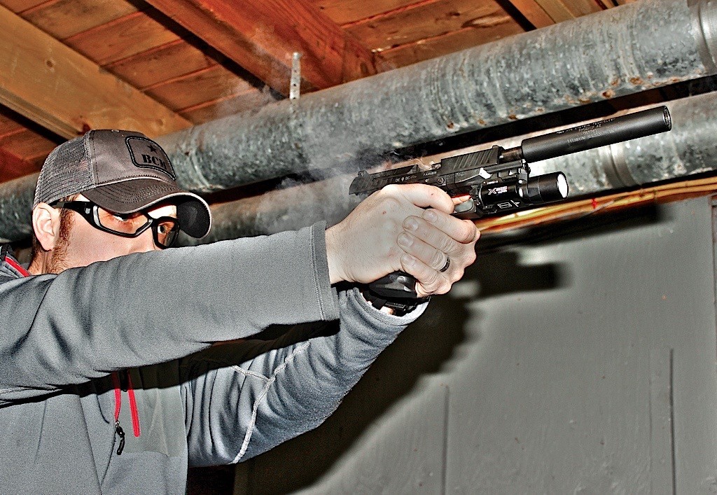 In a nice change of pace, we stepped out of the winter cold and into our fully equipped basement range to put some rounds through a suppressed PPQ M2 “Navy” model.