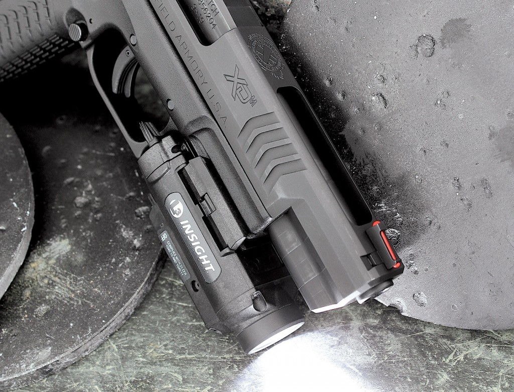 The forged-steel slide receives a sizable lightening cut-out in order to reduce reciprocating mass. The dovetailed fiber- optic front sight proved bright and quick. An Insight Technology WL1-AA weapon light/laser combination sits nearly flush with the muzzle of the 5.25.