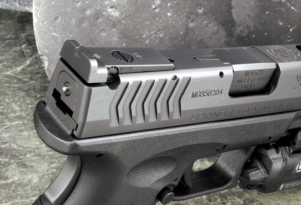 The fully adjustable rear sight is nicely recessed into the slide. Note the protruding cocking indicator at the rear, and ambidextrous magazine release. 