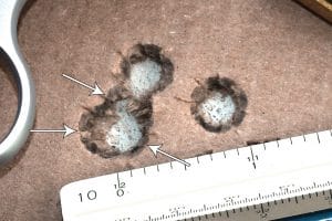 Arrows show three distinct radii of the 3 shots in one hole; even with the two outlying holes, the group is 0.85” between the farthest a part hits. Impressive by any standard.