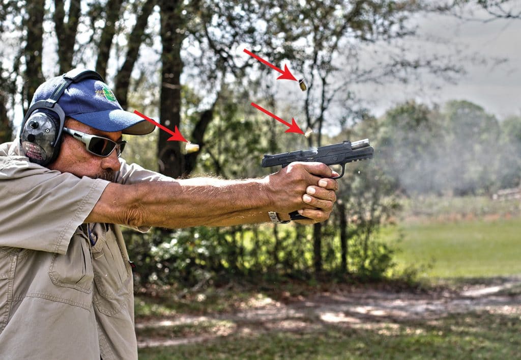 Arrows point to airborne spent shell casings as the author demonstrates the American’s excellent controllability during rapid fire.