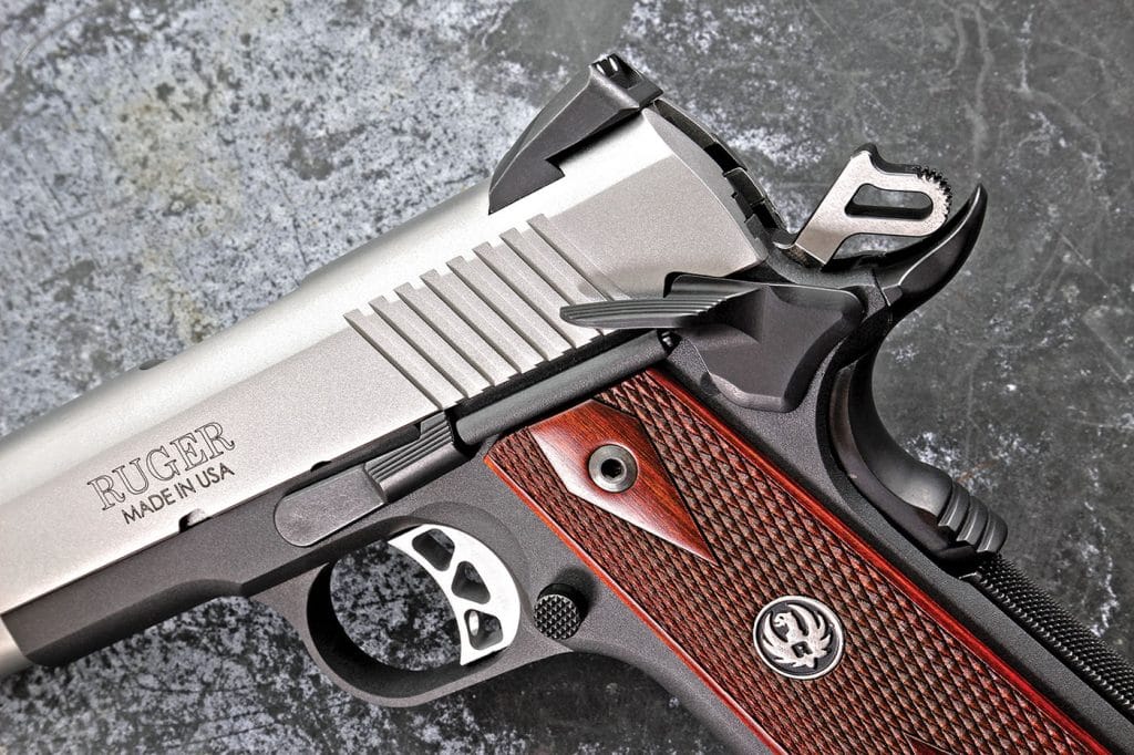 The lightweight, anodized-aluminum frame is fitted with Slim hardwood grips , extended magazine release, slide stop and thumb safety and oversized beavertail grip safety.