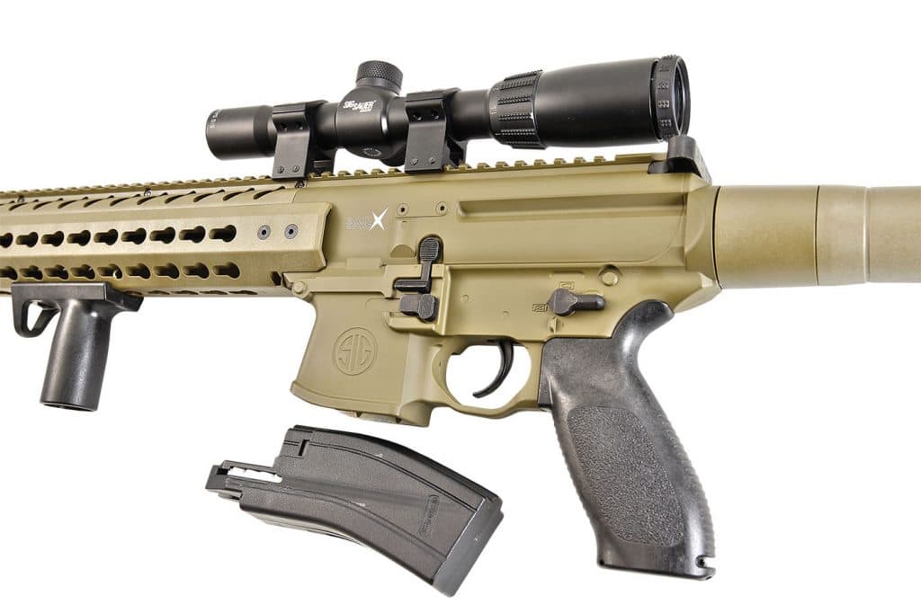 The MCX ASP, shown with the optional 1-4x24 SIG scope, feeds from a reliable 30-round magazine—inserted and released just like the real-deal MCX rifle.